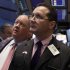 In this May 11, 2012, photo, trader Edward Curran, right, works on the floor of the New York Stock Exchange. Wall Street was headed for a higher opening Tuesday May 15, 2012, with Dow Jones industrial futures rising 0.4 percent  while S&P 500 futures added 0.5 percent.  (AP Photo/Richard Drew)