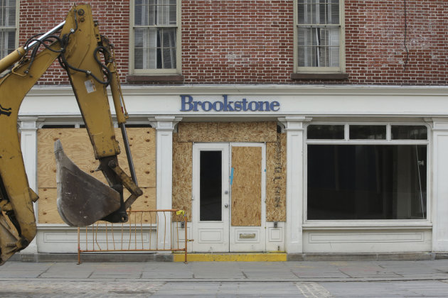 <p>               In this Thursday, Feb. 7, 2013 photo, a backhoe is driven past the shuttered Brookstone store on Fulton St. in New York. Nearly four months after Superstorm Sandy hit, the historic cobblestone streets near the water's edge in lower Manhattan are eerily deserted, and among local business owners, there is a pervasive sense that their plight has been ignored by the rest of Manhattan. (AP Photo/Mary Altaffer)