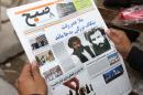 In this Saturday, Aug. 1, 2015 file photo, an Afghan man reads a local newspaper with photos of the new leader of the Afghan Taliban, Mullah Akhtar Mansoor, center, and former leader Mullah Mohammad Omar who was declared dead, in Kabul, Afghanistan. The new leader of the Afghan Taliban said on Friday, Oct. 2, 2015 that the capture of the northern Afghan city of Kunduz was a "symbolic victory" that showed the strength of the insurgency — even though the Taliban pulled out of the city after three days. (AP Photo/Massoud Hossaini, File)