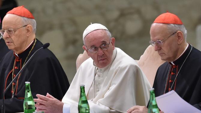 Pope Francis (C), cardinal Lorenzo Baldisseri (L), general secretary of the Synod, and cardinal Peter Erdo (R), relator general of the Synod, attend the commemoration of the 50th anniversary of the Synod of Bishops on October 17, 2015 at the Vatican