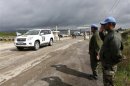 United Nations peacekeepers salute as a U.N. vehicle crosses from Syria into Israel at the Kuneitra crossing on the Golan
