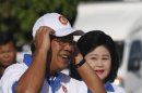 Cambodia's Prime Minister Hun Sen and his wife Bun Rany arrive at an election campaign area in Phnom Penh