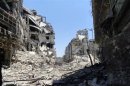 Damaged buildings are seen in Juret al-Shayah in Homs