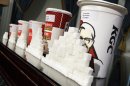 FILE - This May 31, 2012 file photo shows a display of various size cups and sugar cubes at a news conference at New York's City Hall. A judge struck down New York City's groundbreaking limit on the size of sugar-laden drinks Monday, March 11, 2013 shortly before it was set to take effect, agreeing with the beverage industry and other opponents that the rule is arbitrary in applying to only some sweet beverages and some places that sell them. (AP Photo/Richard Drew, File)