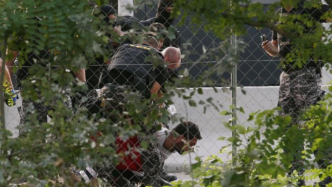 A young refugee is arrested by Hungarian Police as migrants attempted to break out from the no-man&#39;s land between the two countries at the Hungarian-Serbian border in Roszke on September 16, 2015