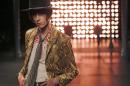 A model wears a creation by French-born designer Hedi Slimane for Saint Laurent men's Spring-Summer 2015 fashion collection, presented in Paris, Sunday, June 29, 2014. (AP Photo/Jacques Brinon)