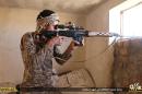 In this photo released on June 23, 2015, by a website of Islamic State militants, an Islamic State militant looks through the scope of his rifle in Kirkuk, northern Iraq. Though best known for its horrific brutalities _ from its grotesque killings of captives to enslavement of women _ the Islamic State group has proved to be a highly organized and flexible fighting force, according to senior Iraqi military and intelligence officials and Syrian Kurdish commanders on the front lines. (Militant website via AP)