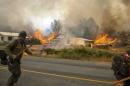 Firefighters flee as the Twisp River fire advances unexpectedly near Twisp, Washington