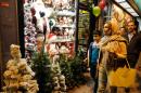 Iranians walk past Christmas decoration at a shop in the capital Tehran on Christmas Eve, December 24, 2016