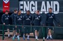 England's Ashley Cole, 3rd right, shares a joke with Theo Walcott, 4th left, during a team training session, London Colney, Thursday Oct. 11, 2012. England will play against San Marino in a World Cup qualifying soccer match on Friday. (AP Photo/Tom Hevezi)