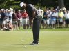 Woods of U.S. putts on the green of the 7th hole during the first round of the Deutsche Bank Championship golf tournament in Norton