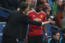 Manchester United's Dutch manager Louis van Gaal (L) gives instructions to Manchester United's Dutch defender Timothy Fosu-Mensah during an English Premier League football match against Manchester City on March 20, 2016