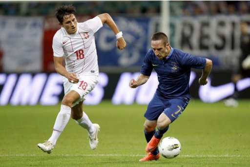 France's Franck Ribery is challenged by Serbia's Ljubomir Fejsa during their international friendly soccer match at Auguste Delaune's stadium in Reims