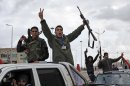 Libyan gunmen celebrate on the early morning of the second anniversary of the revolution that ousted Moammar Gadhafi, in Benghazi, Libya, Sunday, Feb, 17 2013. (AP Photo/Mohammad Hannon)