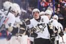 Sidney Crosby of the Pittsburgh Penguins celebrates with the bench after scoring his team's second goal against the Edmonton Oilers during an NHL game at Rexall Place on January 10, 2014 in Edmonton, Alberta