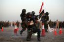 Iraqi soldiers perform a military exercise during their graduation ceremony in Kufa, on September 1, 2014