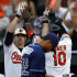 Baltimore Orioles' Mark Reynolds, left, and Adam Jones (10) celebrate after Jones scored on a single by teammate Manny Machado as Tampa Bay Rays pitcher Chris Archer, front, walks off the field after a baseball game in Baltimore, Thursday, Sept. 13, 2012. Baltimore won 3-2 in 14 innings. (AP Photo/Patrick Semansky)