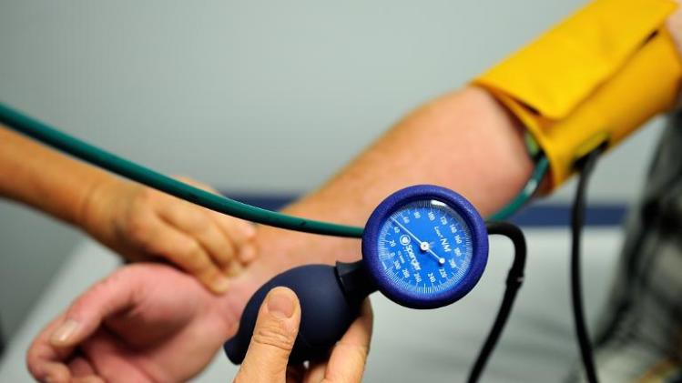 A nurse measures the blood pressure of a patient, on September 20, 2013 in Lens