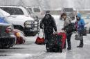 Holiday travelers make their way to their car after arriving at Pittsburgh International Airport in Imperial, Pa., Tuesday, Nov. 26, 2013. Winter weather advisories and storm warnings have been posted for much of Pennsylvania as a storm bearing a wintry mix of precipitation rolls into the commonwealth. (AP Photo/Gene J. Puskar)
