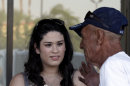 In this Friday, June 29, 2012 photo, Carissa Valdez, left, a volunteer for President Barack Obama's reelection campaign, listens to Ruben Gallardo, who she registers to vote, as a group of volunteers work to register new voters as they canvass a heavily Latino neighborhood in Phoenix. Across the country both political parties have been courting the Latino vote, the nation's fastest-growing minority group. (AP Photo/Ross D. Franklin)