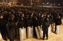 Riot police deploy on the street in front of barricades built by pro-European integration protesters at Independence Square in Kiev