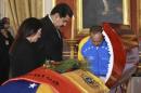 Venezuela's President Maduro, his wide Cilia and national assembly president Cabello stand next to the coffin of slain lawmaker Serra during a wake ceremony at the National Assembly in Caracas