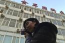 Wang Yu, the lawyer of human right activist Cao Shunli, talks on the phone in front of a hospital building where Cao is hospitalized at its intensive care unit in Beijing