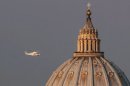 A helicopter carrying Pope Benedict XVI passes St. Peter's Basilica on its way out of Vatican City.