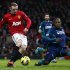 Manchester United's Rooney shoots past Sunderland's Bramble during their English Premier League soccer match at Old Trafford in Manchester