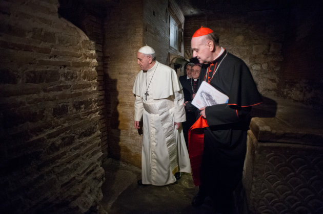 In this picture made available by the Vatican newspaper L'Osservatore Romano, Pope Francis, followed by Cardinal Angelo Comastri, right, and Bishop Vittorio Lanzani, partially hidden, visits the necropolis where pagans and early Christians were buried under St. Peter’s Basilica at the Vatican and where St. Peter is believed to be buried, Monday, April 1, 2013, during what was called the first-ever visit by a pope. The basilica was built over the location where early Christians would gather in secret, at a time of persecution in ancient Rome, to pray at an unmarked tomb believed to be that of Peter, the apostle Jesus chose to lead his church. (AP Photo/L'Osservatore Romano)