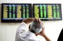 A Chinese stock investor reacts near a display for stock prices at a brokerage house in Qingdao in eastern China's Shandong province Tuesday, Aug. 25, 2015. Chinese stocks tumbled again Tuesday after their biggest decline in eight years while most other Asian markets rebounded from a day of heavy losses. (Chinatopix via AP) CHINA OUT