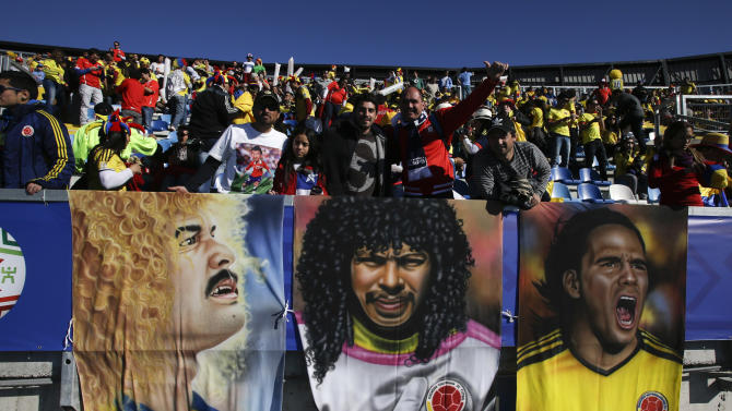 Colombia&#39;s fans holding banners of Colombia soccer starts cheer before the start of a Copa America Group C soccer match between Colombia and Venezuela at El Teniente stadium in Rancagua, Chile, Sunday, June 14, 2015. (AP Photo/Luis Hidalgo)