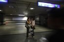 Commuters talk on mobile phone inside a Metro station after Delhi Metro rail services were disrupted following power outage in New Delhi, India, Tuesday, July 31, 2012. A massive blackout hit northern and eastern India on Tuesday afternoon, leaving 600 million people without electricity in one of the world's most widespread power failures. The outage came just a day after India's northern power grid collapsed for several hours leaving cities and villages across eight states powerless.(AP Photo/ Rajesh Kumar Singh)