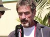 In this Thursday Nov. 8, 2012 photo software company founder John McAfee speaks at the official presentation of equipment ceremony that took place at the San Pedro Police Station in Ambergris Caye, Belize. McAfee, 67, has been identified as a "person of interest" in the killing of his neighbor, 52-year-old Gregory Viant Faull, whose body was found on Sunday. Police are urging McAffe to come in for questioning. (AP Photo/Ambergris Today Online-Sofia Munoz)
