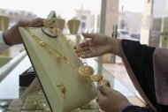 A woman looks at jewellery at a shop in the gold market in Riyadh, March 11, 2013. REUTERS/Stringer/Files