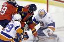 New York Islanders goalie Thomas Greiss (1) stops a shot as he defends against Florida Panthers left wing Garrett Wilson (28) and Logan Shaw (48) during the second period of Game 5 of an NHL hockey first-round Stanley Cup playoff series, Friday, April 22, 2016, in Sunrise, Fla. (AP Photo/Alan Diaz)