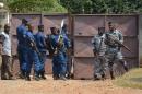 Burundi police officers guard the scene where the vehicle driven by late Burundi minister Hafsa Mossi was stored for forensic investigation, after the murder of the close ally of President Pierre Nkurunziza on July 13, 2016