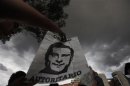 A protester holds a poster of Enrique Pena Nieto during a demonstration outside Mexico's electoral court in Mexico City