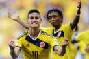 Colombia's James Rodriguez (10) celebrates with teammate Colombia's Juan Cuadrado after scoring his side's first goal during the group C World Cup soccer match between Colombia and Ivory Coast at the Estadio Nacional in Brasilia, Brazil, Thursday, June 19, 2014. (AP Photo/Fernando Llano)