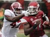 Arkansas quarterback Brandon Mitchell, right, carries against Alabama linebacker Xzavier Dickson (47) during the first quarter of an NCAA college football game in Fayetteville, Ark., Saturday, Sept. 15, 2012. (AP Photo/Danny Johnston)