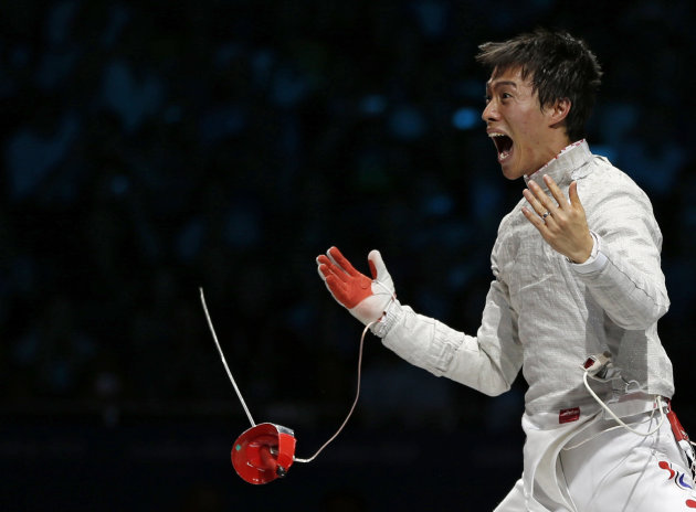 South Korea's Woo Young Won celebrates his team's victory at the end of their men's sabre team gold medal fencing competition against Romania at the London 2012 Olympic Games