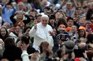 Pope Francis waves to faithful as he is driven through the crowd with his popemobile in St. Peter's Square prior to the start of his weekly general audience at the Vatican, Wednesday, April 10, 2013. (AP Photo/Alessandra Tarantino)