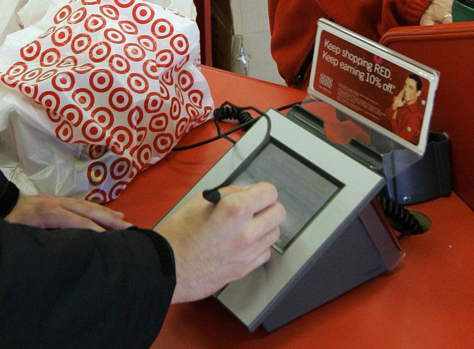 FILE - In this Jan. 18, 2008 file photo, a customer signs his credit card receipt at a Target store in Tallahassee, Fla. Target says that about 40 million credit and debit card accounts customers may have been affected by a data breach that occurred at its U.S. stores between Nov. 27, 2013, and Dec. 15, 2013. (AP Photo/Phil Coale, File)