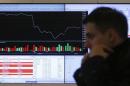 A man walks past an information screen on display inside the office of the Moscow Exchange in the capital Moscow