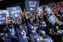 South Africa main opposition party Democratic Alliance supporters hold signs as they attend a campaign rally on April 23, 2016 at the Rand Stadium in Johannesburg