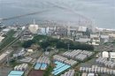 An aerial view shows TEPCO's tsunami-crippled Fukushima Daiichi nuclear power plant and its contaminated water storage tanks in Fukushima