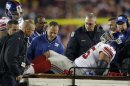 New York Giants tackle Sean Lockler is loaded on to a cart after suffering an injury against the Washington Redskins in the second half of their NFL football game in Landover, Maryland December 3, 2012. REUTERS/Gary Cameron