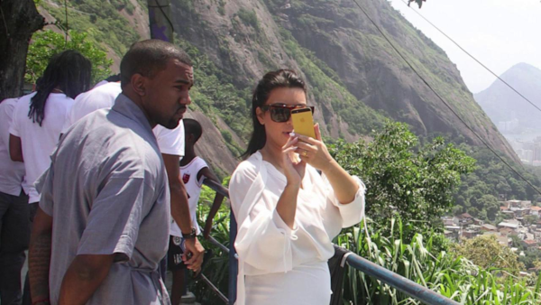 Pregnant Kim Kardashian Shows Off Her Kurves in Sheer Plunging Tops ...