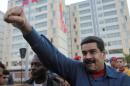 Venezuela's President Nicolas Maduro greets supporters as he arrives to an event for handing over houses in Caracas