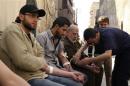 Men donate blood during a campaign to supply blood to field hospitals in Aleppo
